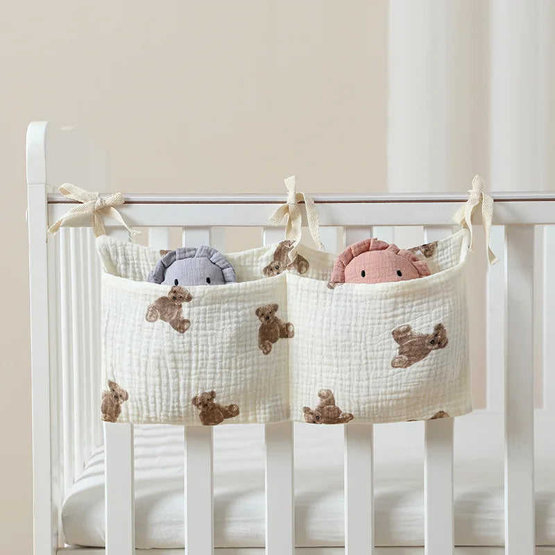 Crib organizer with teddy bear toys hanging inside a crib.