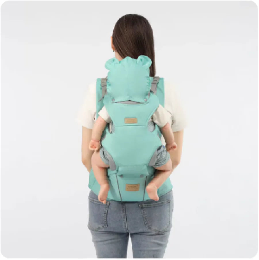 Person using a turquoise baby carrier with a white background