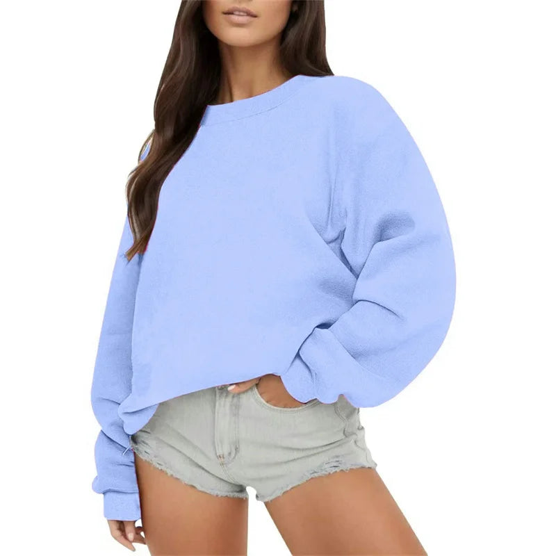 Light blue oversized sweatshirt worn by a person on a white background