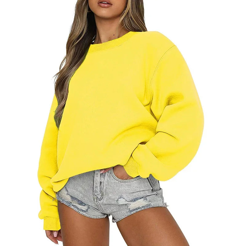 Person wearing a bright yellow sweatshirt and denim shorts on a white background