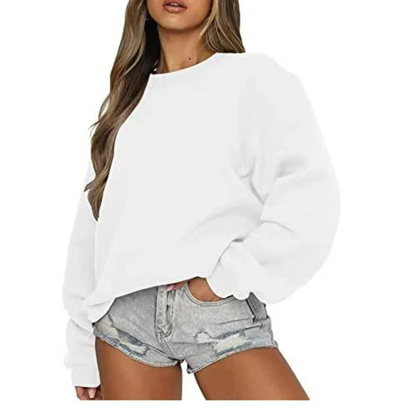 Person wearing a white sweatshirt and denim shorts on a white background