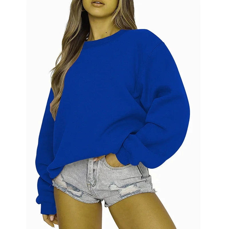 Person wearing a blue sweatshirt and denim shorts on a white background