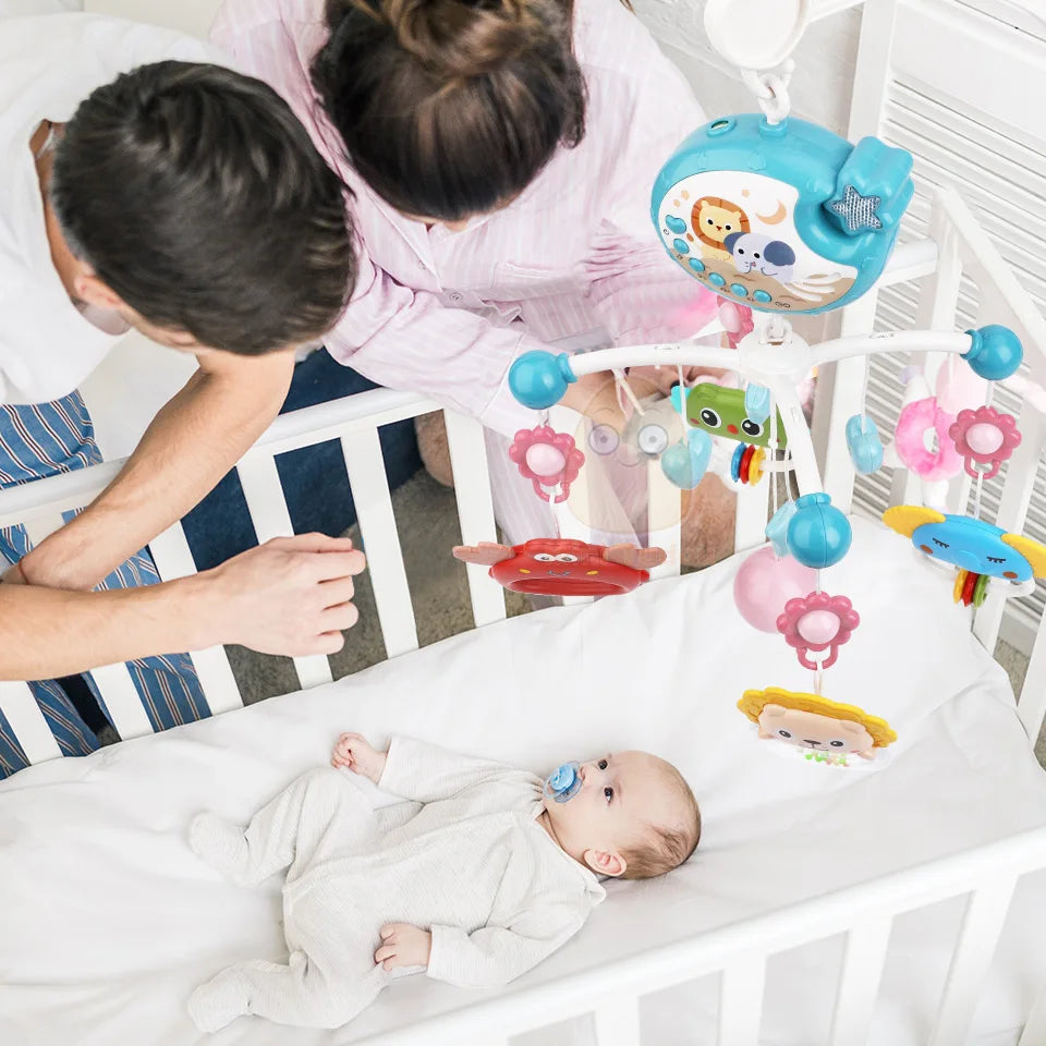 Baby in crib with colorful mobile and parents interacting