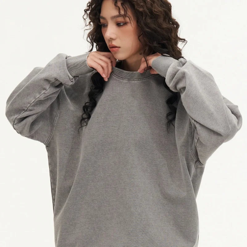 Person wearing a gray sweatshirt on a white background