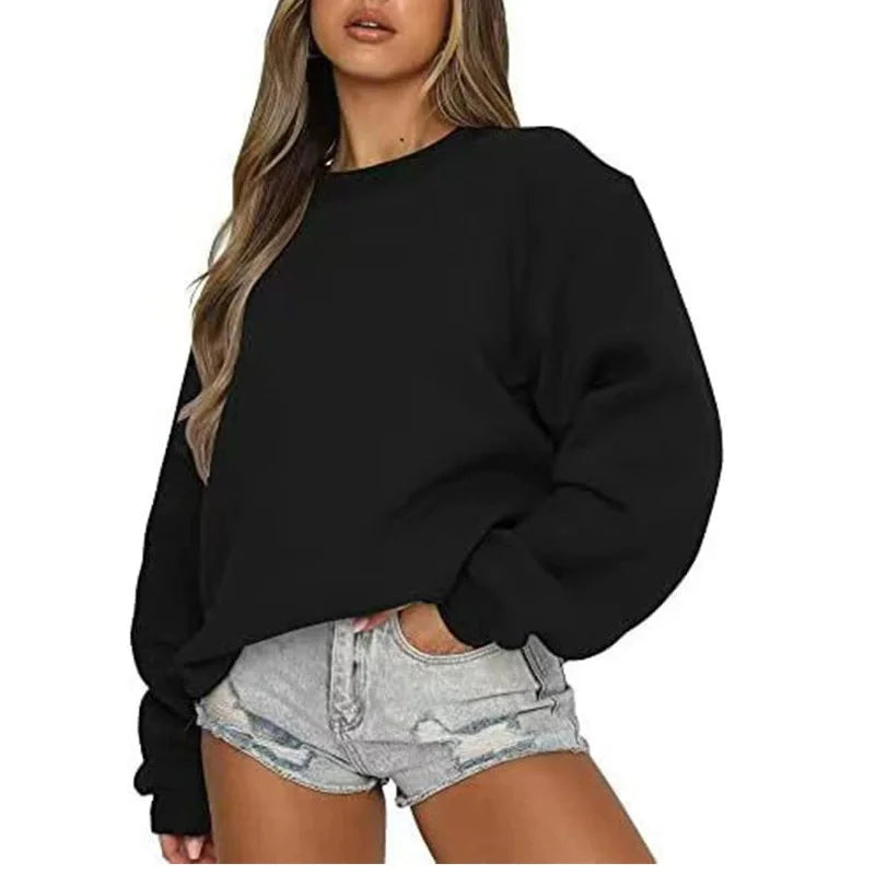 Person wearing a black sweatshirt and denim shorts on a white background