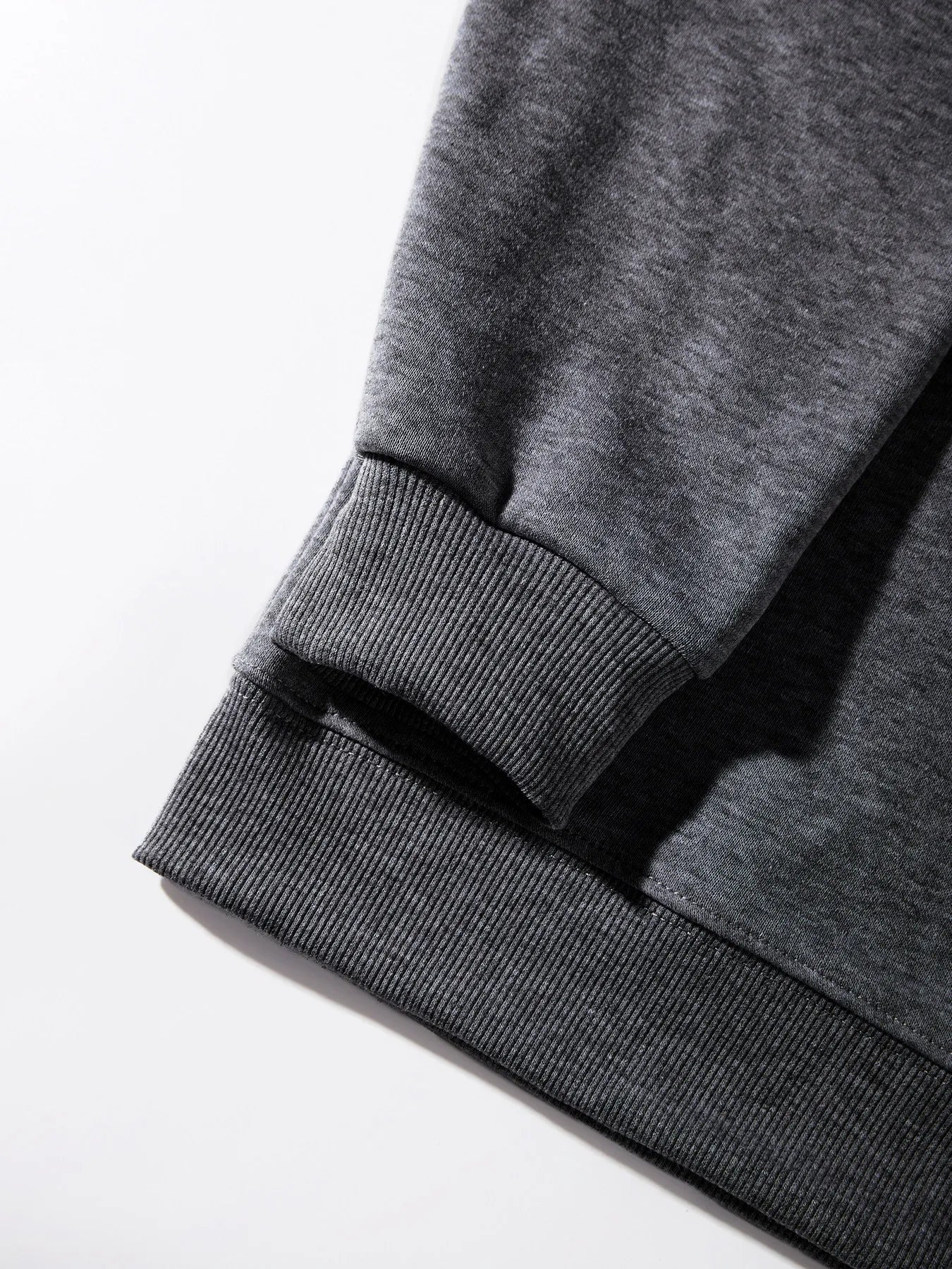 Close-up of a gray sweatshirt with a white background