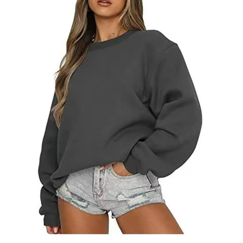 Person wearing a dark gray sweatshirt and light denim shorts on a white background
