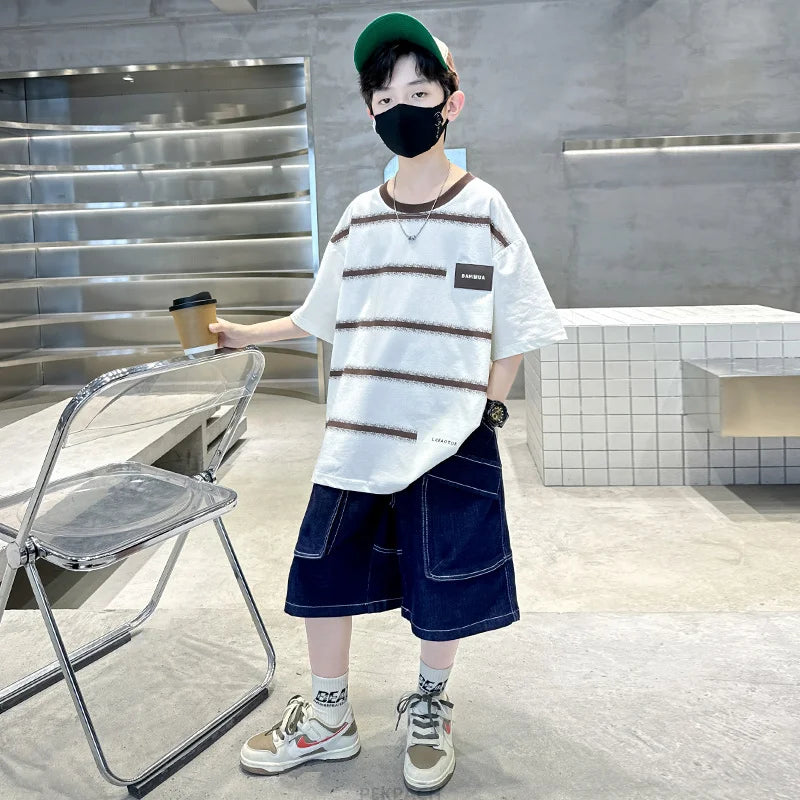 Person wearing a striped shirt and denim shorts in an indoor setting