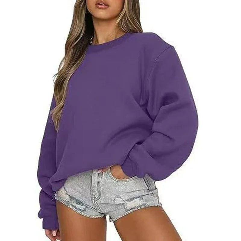 Person wearing a purple sweatshirt and denim shorts on a white background