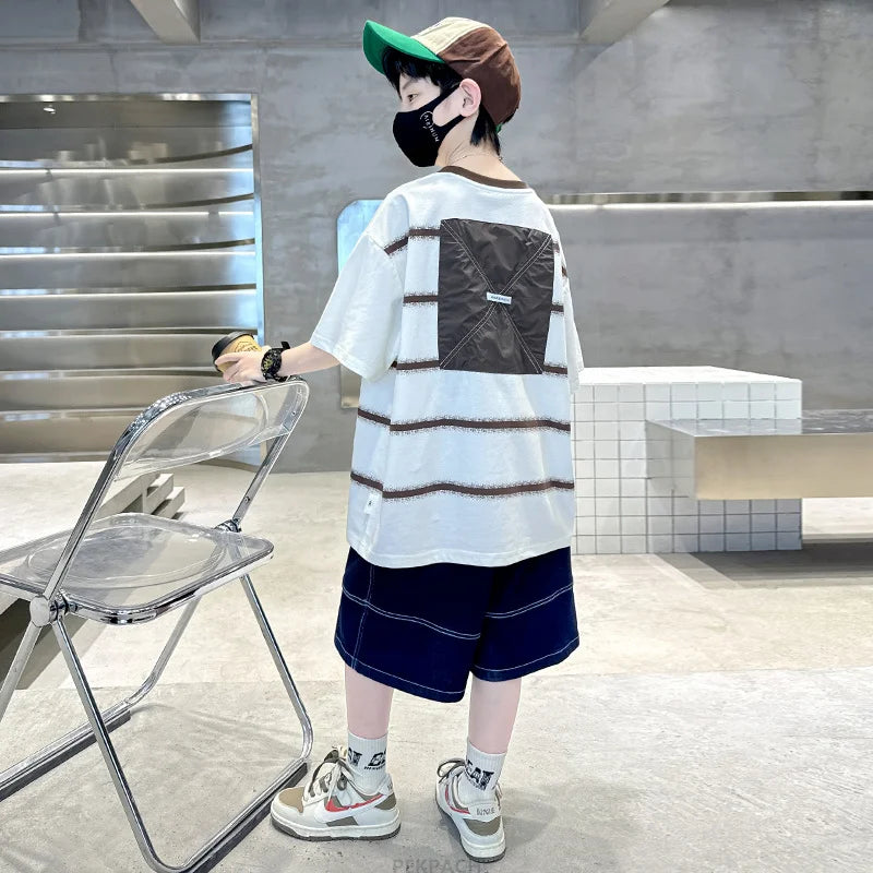 Person wearing a striped shirt and shorts in an indoor setting