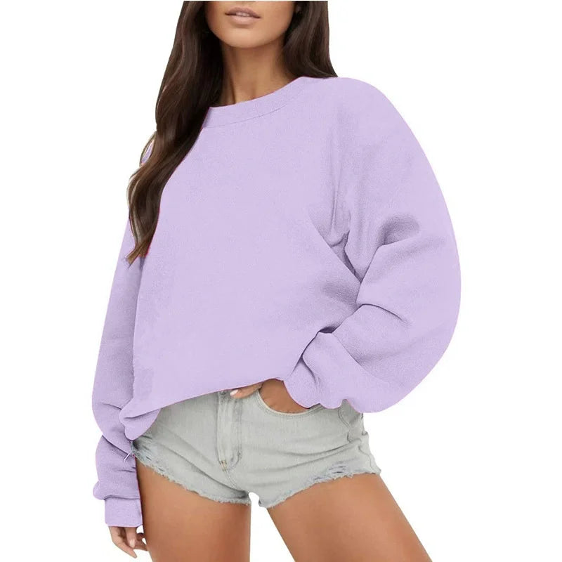 Person wearing a light purple sweatshirt and denim shorts on a white background