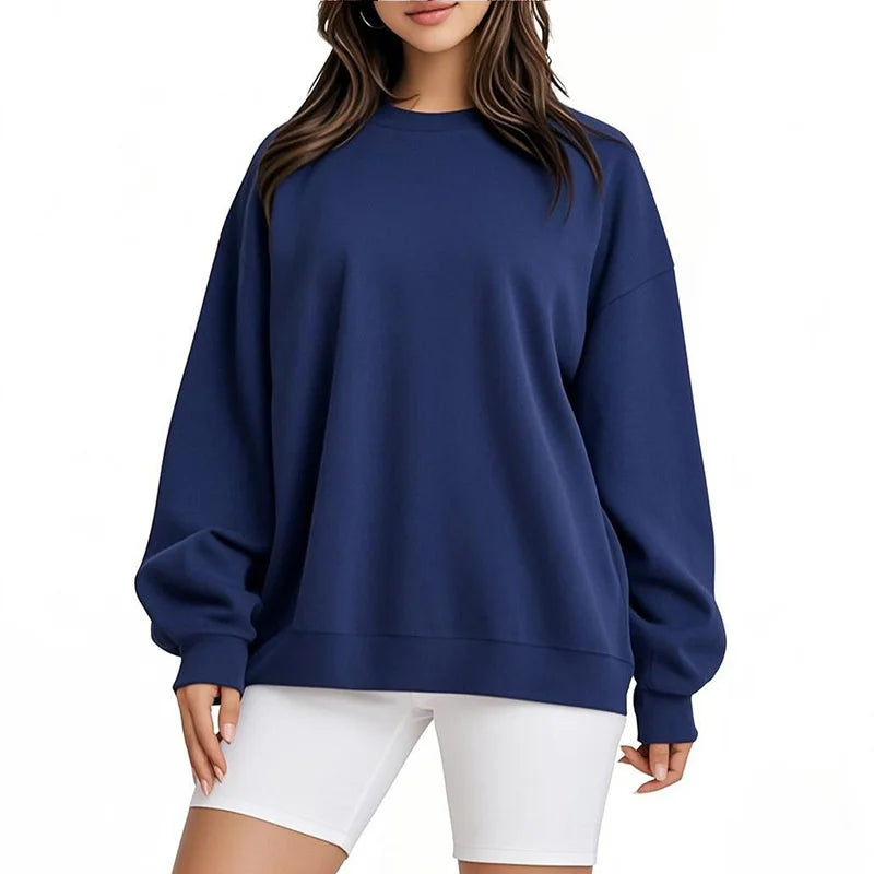 Person wearing a blue sweatshirt and white shorts on a white background