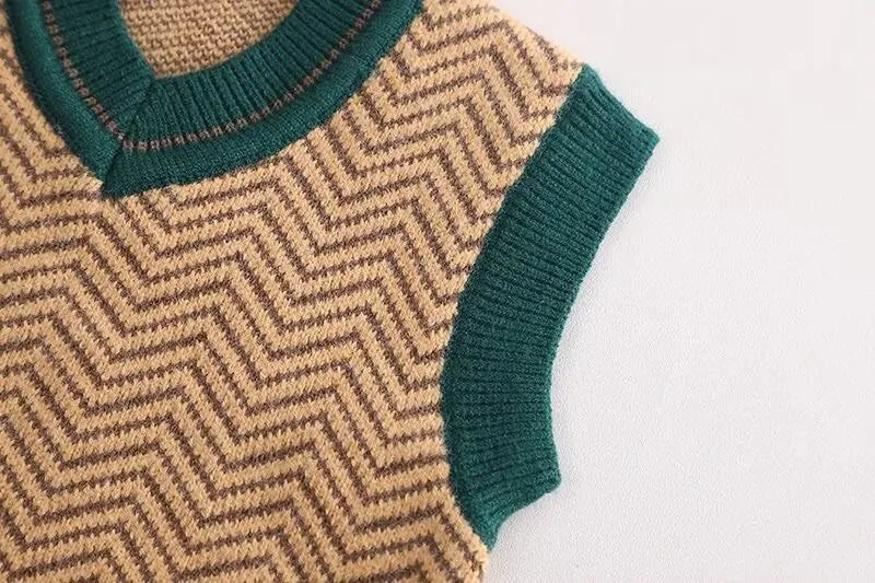 Close-up of a sweater with green neckline and sleeve on a white background