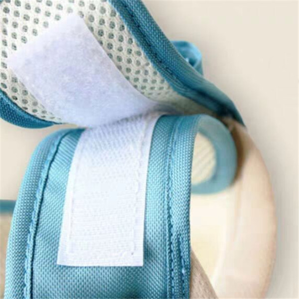 Close-up of a blue and white baby carrier with a neutral background