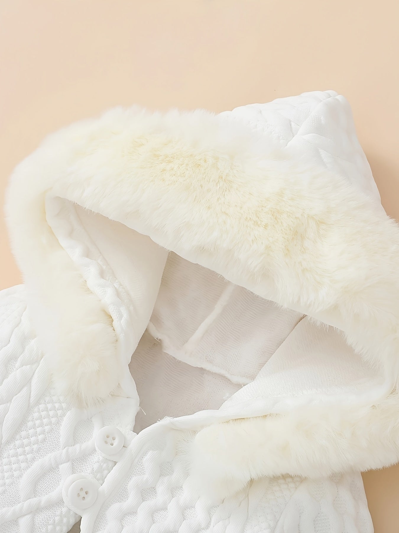 Close-up of a white textured fabric with a beige background